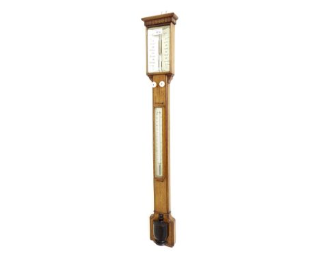 Oak stick barometer, the silvered angled scale signed H. Wadham, Bath over a flat trunk fitted with a thermometer and ebonise