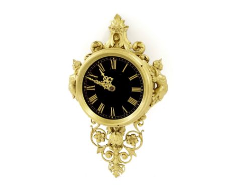 Gilt metal cartel style wall clock, the 5.75" black dial within a turned surround and ornate foliate pierced case with mermai