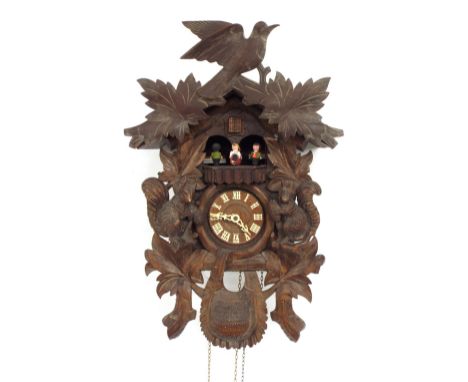 Black Forest cuckoo clock, the 3.5" dial under a platform with four revolving figures, within a chalet case carved with squir