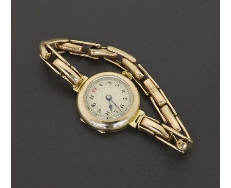 Early 20th century 9ct lady's bracelet watch with expanding bracelet, silvered dial with Arabic numerals and red twelve, 15 j
