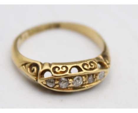 An Edwardian 18ct gold five stone boat shape diamond ring, Birmingham 1906, size L and an 18ct gold diamond set daisy cluster