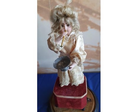 A French lady blowing bubbles automaton with a closed mouth Jumeau head, with brown glass eyes, pierced ears, bisque arms and