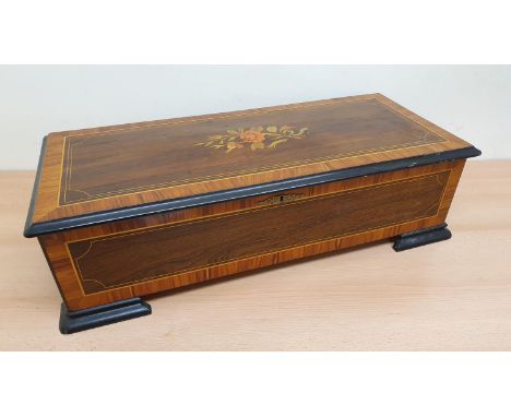 A 19th century Swiss music box with rosewood and boxwood inlay, the single comb movement with Griffin trade mark with 3 cylin