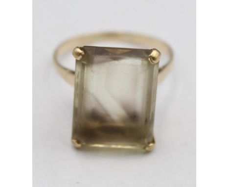 A 9ct gold and smokey quartz dress ring, London 1966, claw set with a step cut stone, 17 x 12 cm, size P 1/2. 