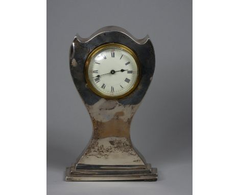 An Edwardian silver cased mantle clock, marks worn, white enamel dial, with Roman numerals, height 21cm, key 