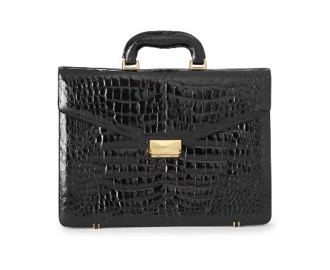 A vintage black glossy crocodile briefcase, featuring polished gold-tone hardware, reinforced top handle, rear slip pocket, f