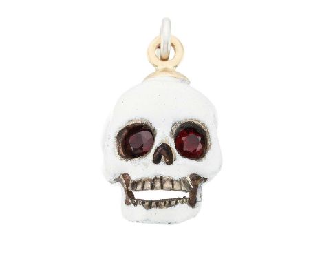 A silver and gold, white enamel memento mori skull pendant, with red garnet eyes, length 2cm, 6.9gOverall good conditionEname