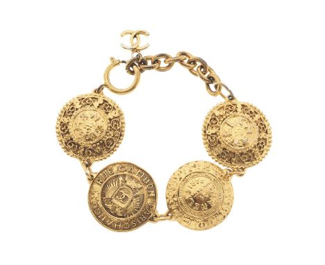 Chanel, a vintage gold-tone coin bracelet, featuring four large domed coins decorated with Chanel's iconic logos, the Rue Cam