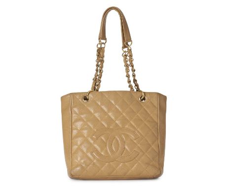 Chanel, a Petite Shopping Tote, crafted from beige caviar leather with diamond quilted detailing and large embroidered CC log