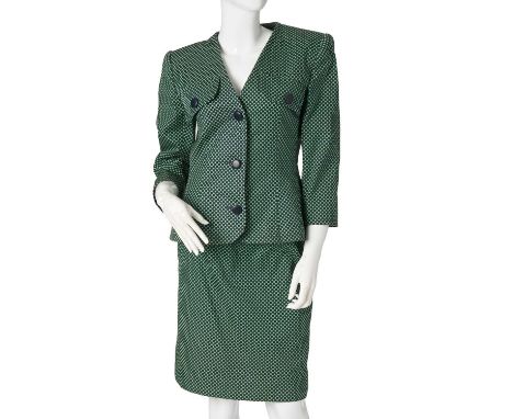 Givenchy, a vintage 1980s skirt suit, featuring a navy blue and green polka-dot fitted jacket, and a matching knee-length pen