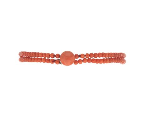 An early 20th century coral bead two-row choker necklace, with yellow metal coral cabochon accent clasp, beads measure approx