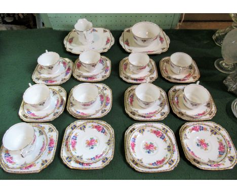 A Wellington China part-tea service, circa 1930's, to include: nine trios, two square sandwich plates, open sugar bowl, milk 