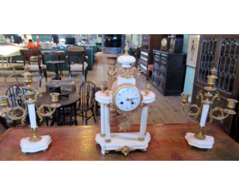 An early 20th century French marble and ormolu clock garniture, bell striking movement, the painted enamel dial bearing Arabi