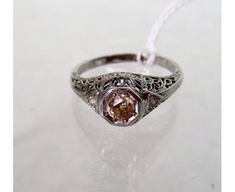 A single stone diamond ring, the old brilliant cut diamond in raised pierced and carved mount, with single stone diamond shou