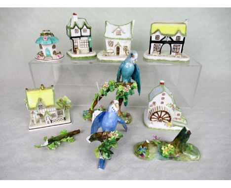 A Crown Staffordshire ceramic budgerigar, perched on flower encrusted stump, designed and modelled by J. T Jones, together wi
