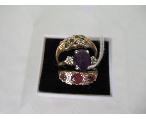 A ruby and diamond half-hoop ring, together with an emerald and diamond crossover ring and an amethyst and diamond ring.