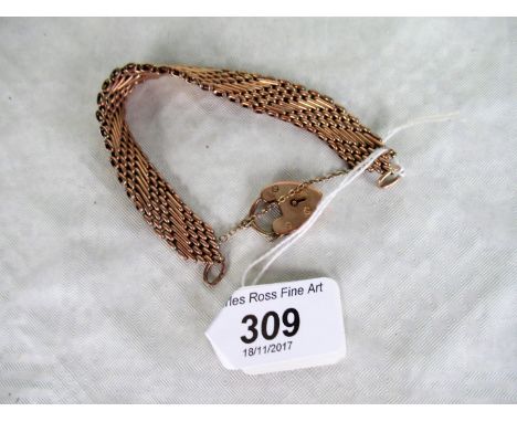 A 9ct gold fancy gate link bracelet, tapering terminals to a padlock clasp. Condition Report: 20.8g