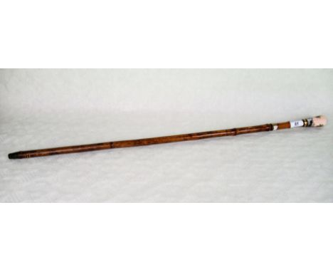 A late 19th/early 20th century bamboo sword stick, having painted enamel handle depicting Egyptian scenes, the stick with bra