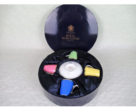 A Royal Worcester boxed four piece coffee set in fitted circular box, dated 2006, marking Queen Elizabeth II 80th birthday.