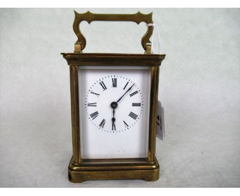A French gilt brass carriage clock, the enamel dial bearing Roman numerals, 14cm (handle up).