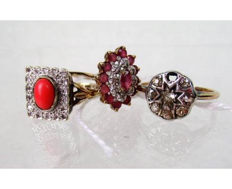 A ruby and diamond cluster ring, together with a diamond cluster ring and a coral and diamond cluster ring.