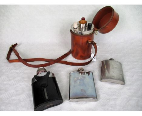 A mid-20th century German tin lined travelling three bottle flask set, the three bottles with enamel covers, to include four 