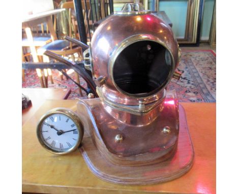 A contemporary novelty desk clock, modelled as a vintage divers helmet in copper and brass, mounted to wooden base, the ename