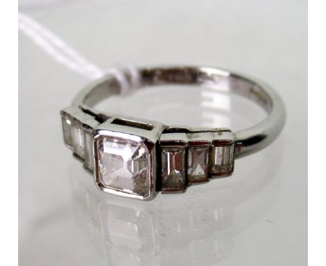 A seven stone half-hoop diamond ring, the central square emerald cut diamond with tapered three stone baguette cut diamond sh