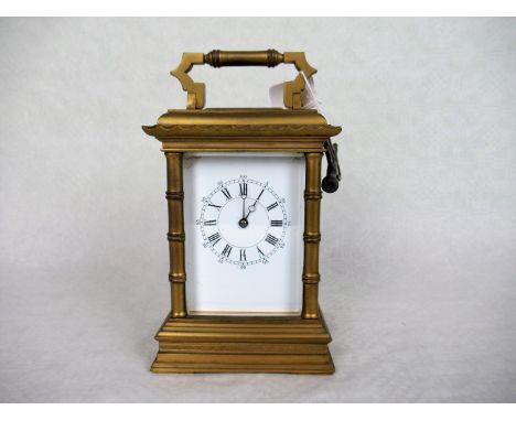 A mid-19th century gilt brass carriage clock, bearing presentation inscription dated 1881, the enamel dial bearing Roman and 