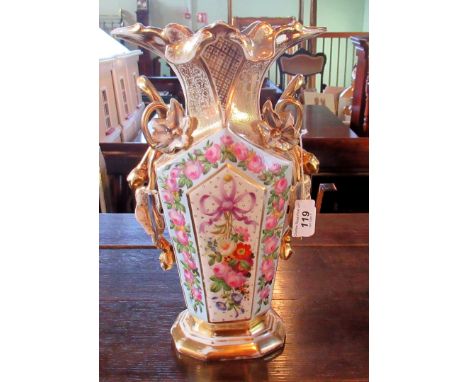 A large Continental ceramic vase, having extensive hand painted floral decoration with gilt finish on an ivory ground, 32cm. 