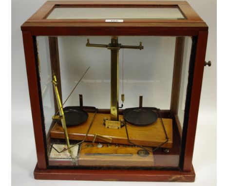 A set of balance scales and weights in a case