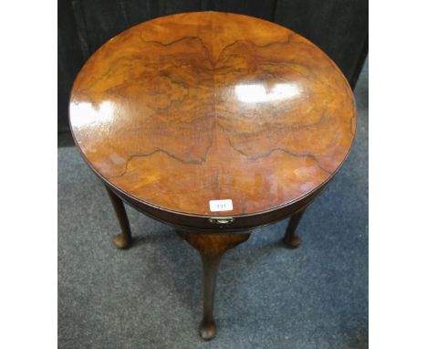 An early 20th century card table burr walnut quarter veneered circular rotating top opening to green baize playing area and s