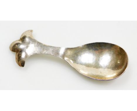 An Arts and Crafts hammered trefoil caddy spoon, by William Thomas Pavitt, London 1913, 9cm long. 