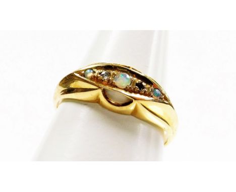 An 18ct gold opal and diamond gypsy ring, the central panel set with three opals and two tiny diamonds, on a flared design ou