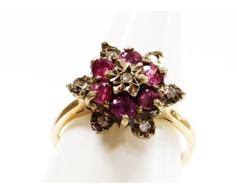 A 9ct gold dress ring, with central garnet and cz cluster, on a raised basket setting, ring size L½, 3.3g all in. 