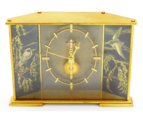 A Jaeger LeCoultre brass mantel clock in the Japanese style, the brass skeleton eight day movement inset with red/pink colour