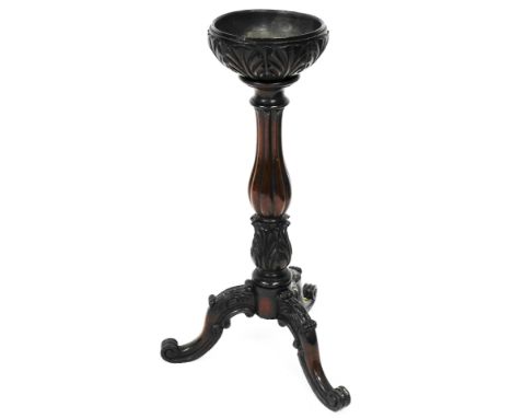 A heavily carved mahogany planter, in the George III style, the circular dish top with an acanthus leaf carving on a reeded b
