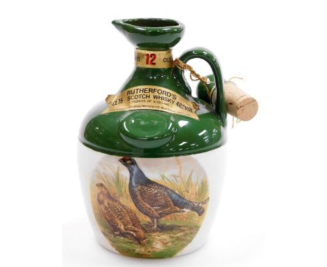 A Rutherford Scotch Whisky decanter, transfer printed with pheasants, with contents (unopened), 20cm high.