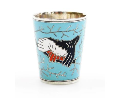 A 20thC Russian white metal and enamel vodka beaker, the enamelled body decorated with a bird and branches on a pale blue gro