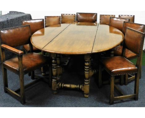 A heavy quality Jacobean style dining room suite, in oak and elm, comprising a wake style oval drop leaf dining table with do