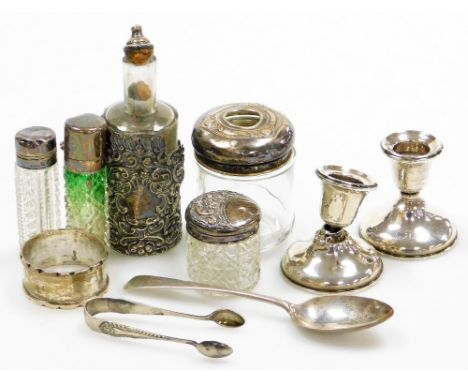 A collection of small silver, to include various glass and silver topped dressing table and scent bottles, a silver napkin ri