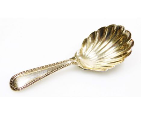 A Victorian silver caddy spoon, with a shell pattern bowl and beaded handle, Exeter 1876, 9cm long. 