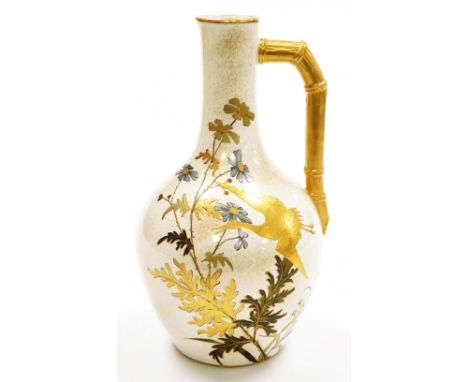 A Royal Worcester porcelain jug, on cream ground, heavily gilt decorated with storks and floral sprays and a bamboo style gil