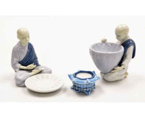 Three Lladro porcelain ornaments, comprising a Lladro figure of a seated monk with bowl, 14cm high, a figure of a kneeling mo