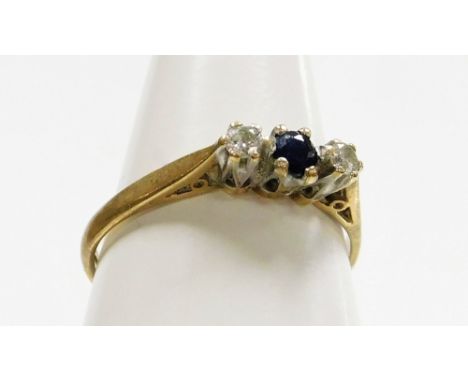 A 9ct gold three stone dress ring, set with tiny sapphire and two diamonds, each in claw setting, ring size L½, 1.4g all in. 