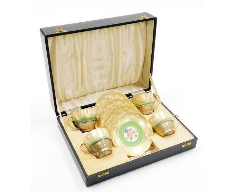 A set of four early 20thC Grosvenor China teacups and saucers, each teacup with a silver engine turned holder with marks for 