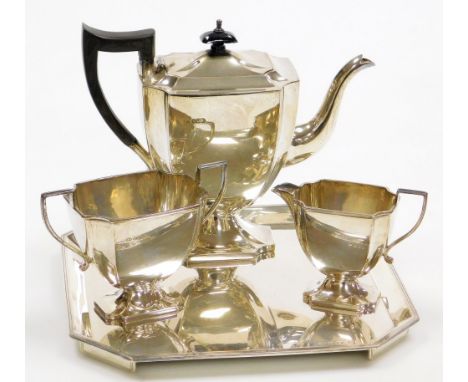 A George V silver three piece tea service, comprising teapot, two handled sugar bowl and milk jug, each with a shaped body an