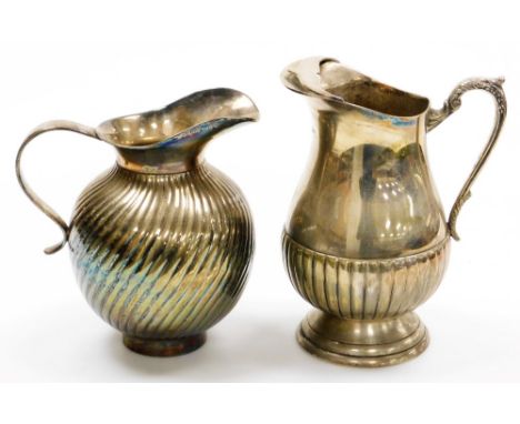 Two early 20thC silver plated jugs, the first with acanthus leaf handle and part gadrooned body, a second with an all over sw