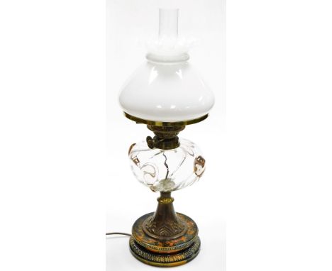 A Victorian oil lamp, with a frosted shade, clear and pink blown glass central reservoir, on a brass column decorated with va