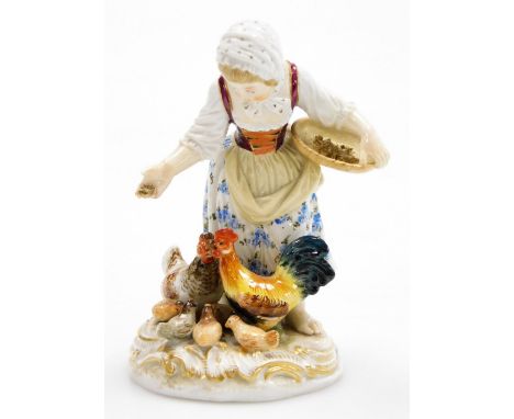 A Meissen porcelain figure group, of a young girl feeding cockerel, chicken and chicks, on a gilt highlighted circular base, 